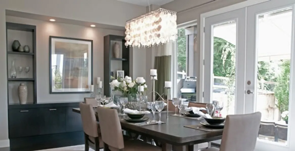 Elegant dining room chandelier installation above table in Bloomington, IN