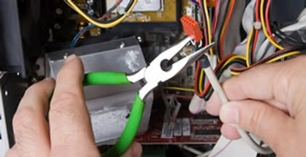 Licensed electrical contractor performing electrical repair with tools in Unionville, IN